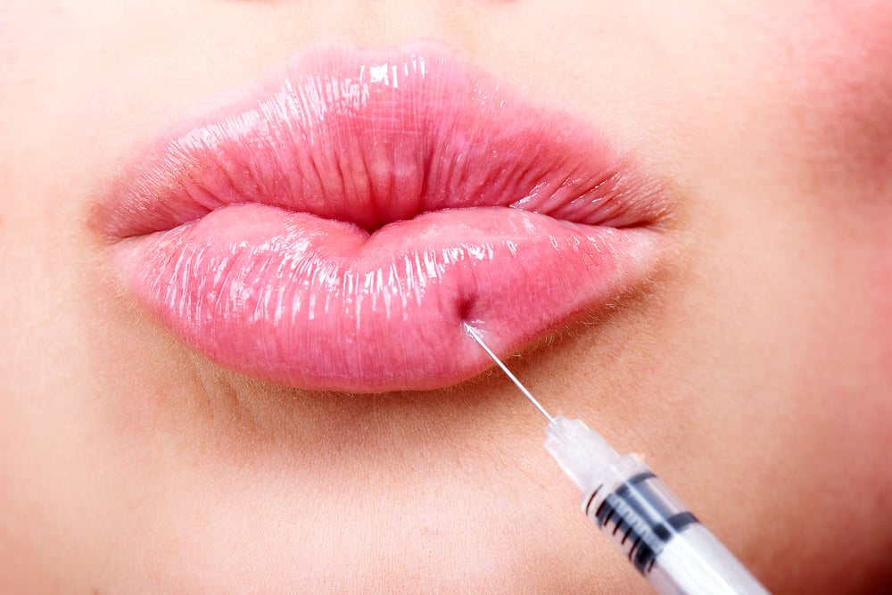 Closeup shot of beautiful young woman receiving filler injection